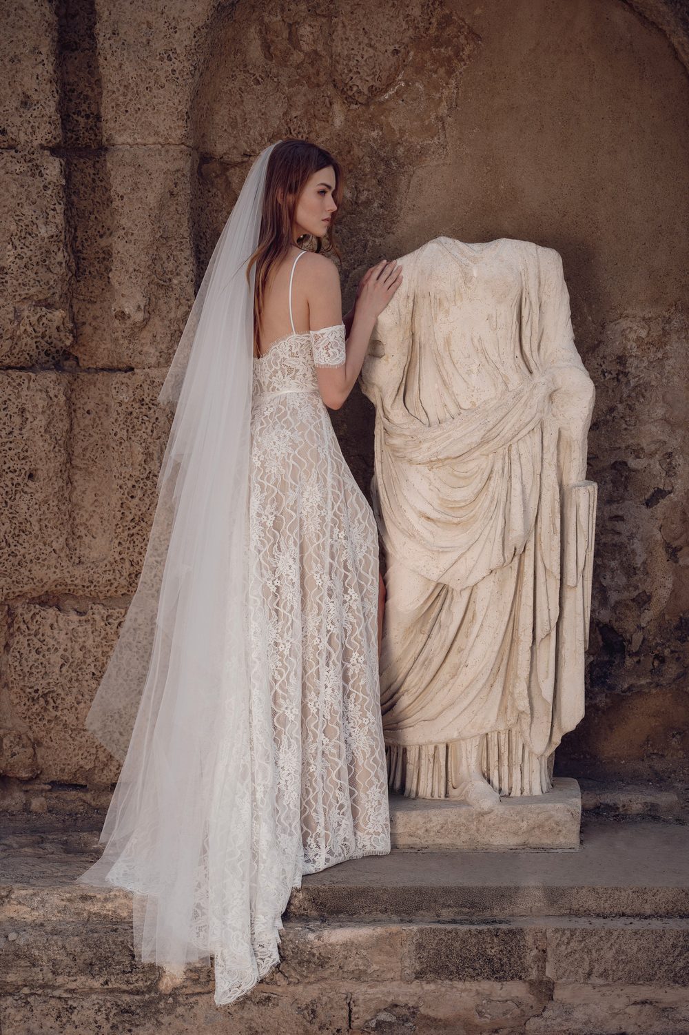 Floor-length plain soft tulle wedding veil worn from a comb, no edging.